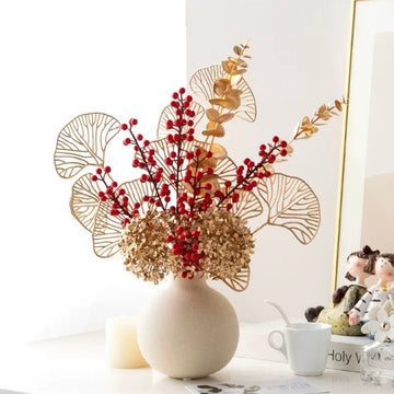 Gold artificial flower bouquet in a matching vase